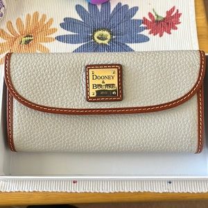 Dooney & Burke wallet with 8 card slots, checkbook slot, and coin pouch on back.